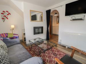 a living room with a couch and a table at Ysgoldy in Dolwyddelan