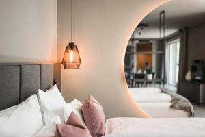 a bedroom with two beds and a mirror at Belia Lofts - ADULTS ONLY - Apartments in Appiano sulla Strada del Vino