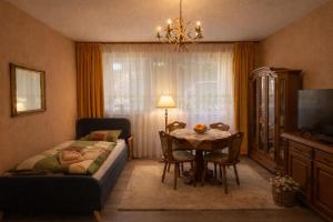 a bedroom with a bed and a table and a bed and a room at Gelsenkirchen Am Flöz in Gelsenkirchen
