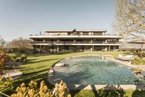 a large house with a swimming pool in front of it at Belia Lofts - ADULTS ONLY - Apartments in Appiano sulla Strada del Vino