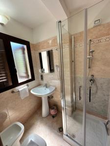 a bathroom with a shower and a sink and a toilet at B&B La Bastia in Scilla
