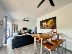 a living room with a table and a couch at Maprao Villa in Mae Nam