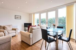 a living room with a glass table and chairs at Host & Stay - 2a Hamilton Road in Felixstowe