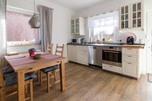 a kitchen with a wooden table and a wooden floor at Ferienwohnung-in-Luebesse in Lübesse +14 photos
