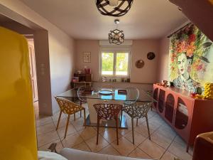 a kitchen and dining room with a table and chairs at Résidences Les Murots 1 in Saint-André-les-Vergers