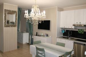a kitchen with a dining table and a chandelier at Tevere 20 House in Monza +19 photos