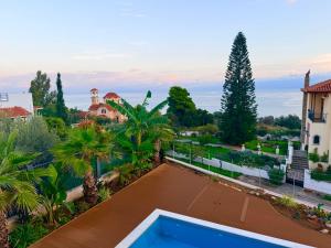 an aerial view of a villa with a swimming pool at Rastoni Sea View Studio with Shared Pool in Melíssion