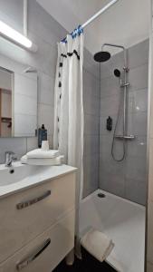 a white bathroom with a shower and a sink at Interlaken in Nice +29 photos