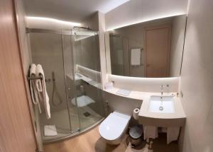 a bathroom with a shower and a toilet and a sink at Casp 74 Apartments in Barcelona +36 photos
