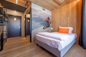 a bedroom with a bed and a painting of a mountain at Montivas Lodge in Livigno +62 photos