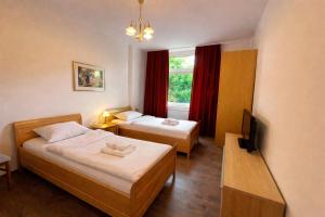 a hotel room with two beds and a television at Gelsenkirchen Am Flöz in Gelsenkirchen