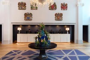 a lobby with a table with flowers on it at The Edwardian Manchester, A Radisson Collection Hotel in Manchester