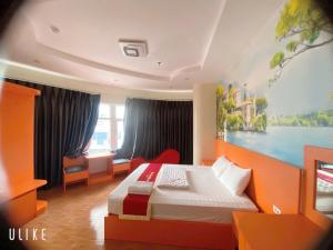a bedroom with a bed and a painting on the wall at Hotel Nam Sơn in Hai Phong
