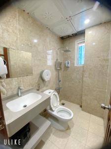 a bathroom with a white toilet and a sink at Hotel Nam Sơn in Hai Phong +16 photos