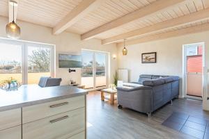 a living room with a couch and a table at Ferienhaus Kampfläufer in Dagebüll