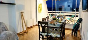 a dining room with a table and some chairs at Marina Nirvana vue sur l'eau in Le Grau-du-Roi