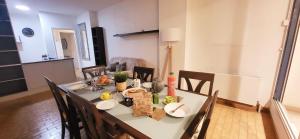 a dining room with a table and chairs with food on it at Marina Nirvana vue sur l'eau in Le Grau-du-Roi +32 photos