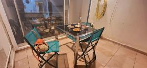 a table and chairs with food on top of it at Marina Nirvana vue sur l'eau in Le Grau-du-Roi