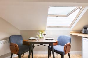 a dining room with a table and two chairs at The Wave - Room 15 in Rhosneigr
