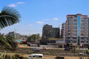 a city with tall buildings and cars on a street at The Quiet Nest in Ruiru