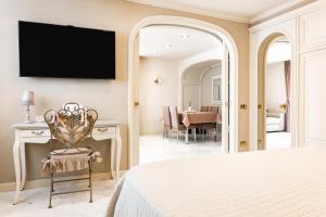 a bedroom with a bed and a dining room at Casa OliVera in Viareggio