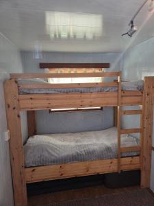 a couple of bunk beds in a room at Lilia Chalet in Durbuy +21 photos