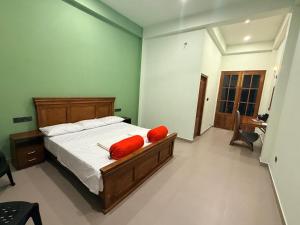 a bedroom with a bed with red pillows on it at The Ceylon Slate in Tangalle +35 photos