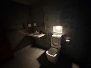 a bathroom with a toilet and a sink at The Ceylon Slate in Tangalle
