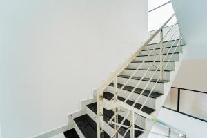a staircase in a building with glass at Hotel O HMT Colony Kochi Formerly Pullans Arcade in Cochin