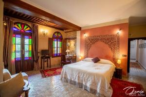 a bedroom with a bed and stained glass windows at Ryad Salama in Fez +64 photos