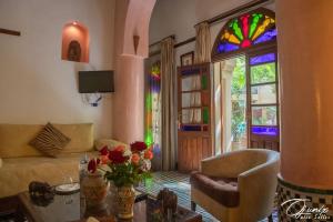 a living room with a couch and a stained glass window at Ryad Salama in Fez