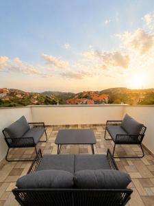 a patio with couches and tables on a roof at Vista Sol in Bicas