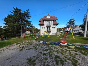 a playground in front of a house with a building at Markov Konak in Divčibare