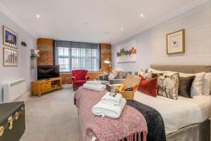 a bedroom with a large bed and a living room at 58 Cocoa Suites Riverside Studio with Parking in York
