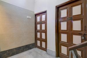 a wooden door in a room with a garage at Super Hotel O Howrah Railway Station in Kolkata