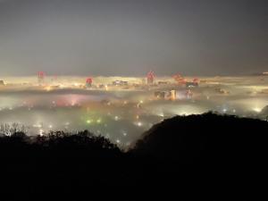a foggy night with a city in the background at Okayama International Hotel in Okayama +89 photos