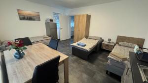 a living room with a table and a dining room at Gästezimmer Fateev 8 in Senden