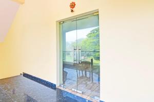 a glass door in a room with a view at Super OYO Townhouse Dwarakanagar Near Gurudwara in Visakhapatnam