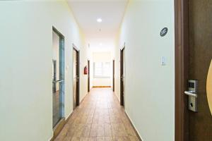 a corridor of an office building with a hallway at Super OYO Townhouse Dwarakanagar Near Gurudwara in Visakhapatnam +42 photos