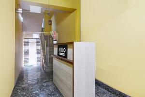 a lobby with a counter with a sign on it at Hotel O Ecopark Kolkata in kolkata