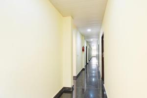a hallway of a hospital with white walls and a long aisle at Super Collection O Godavari Kompally in Hyderabad