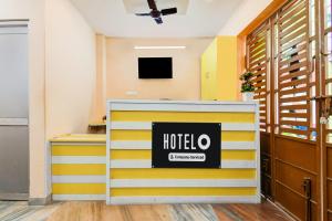 a hotel lobby with yellow and white stripes at Hotel O Dakshin Dwar Formerly Radha Krishna Niwas in Puri