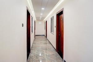 a hallway with two doors and a tile floor at Super Collection O Ganeshpuri Indore in Indore