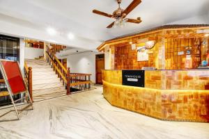 a bar in a restaurant with a ceiling fan at Super Townhouse Rajbagh Formerly Hotel Modern in Srinagar