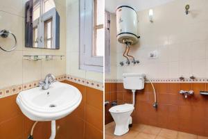 a bathroom with a sink and a toilet and a mirror at Super Townhouse Rajbagh Formerly Hotel Modern in Srinagar