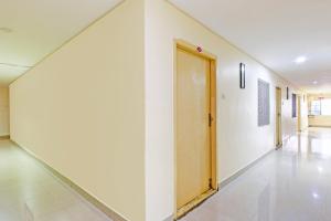 an empty hallway with a door in a building at OYO Collection O NAD Near Airport in Visakhapatnam +39 photos