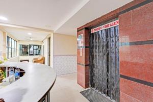 a brick wall with a door in a room at OYO Collection O NAD Near Airport in Visakhapatnam