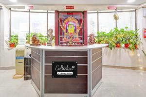 a counter in a room with potted plants at OYO Collection O NAD Near Airport in Visakhapatnam