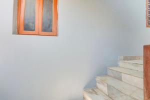 a set of stairs in a room with a window at Super Hotel O Chowrasta Near Congress Bhavan in Warangal