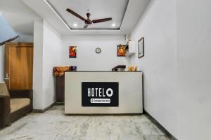 a room with a hotel sign on a wall at Super Hotel O Chowrasta Near Congress Bhavan in Warangal